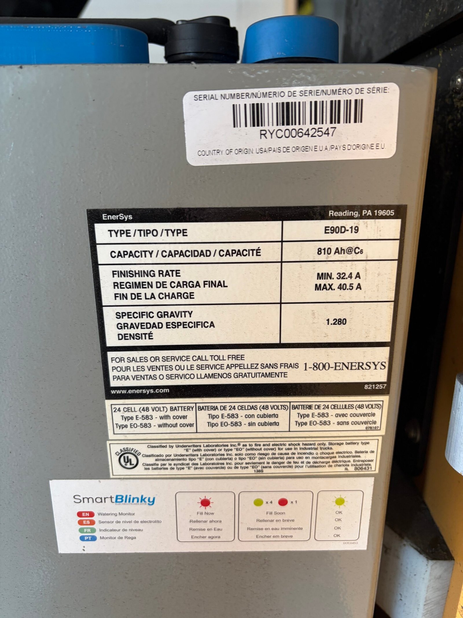 EnerSys 48-volt battery label showing 810 Ah capacity and SmartBlinky electrolyte-level monitor instructions.